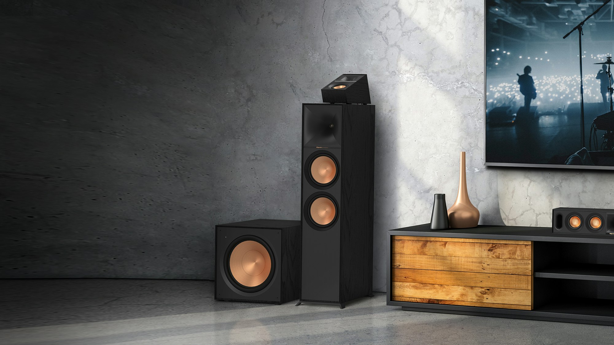 Reference Subwoofer R-121SW next to a Klipsch floorstanding speaker with Dolby Atmos elevation topper